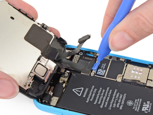 قاب باز کن را در لبه زیرین کانکتور LCD آیفون 5 سی تعمیری قرار داده و آن را از روی برد گوشی جدا کنید.